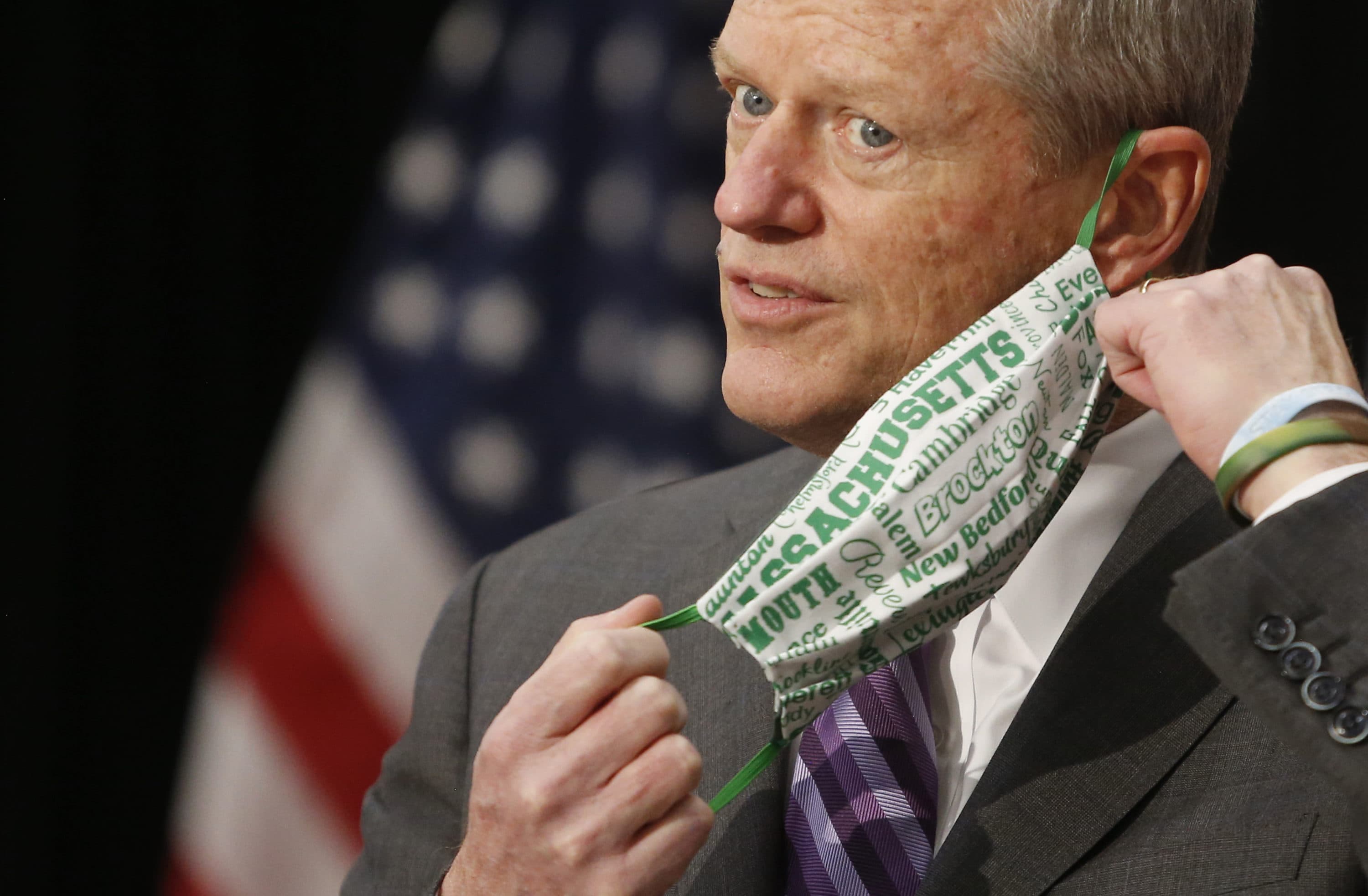 Gov. Charlie Baker removes his mask as he steps to the microphone during a press conference on Monday, April 26, at the State House. (Jessica Rinaldi/The Boston Globe via Getty Images)