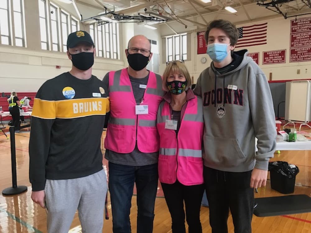 Jennifer Freeman, center right, son Matt, husband Doug and son Andrew at the Lower Merrimack Valley regional vaccine clinic, where the elder Freemans both volunteer. The teens were able to get vaccinated over the weekend. COURTESY JENNIFER FREEMAN