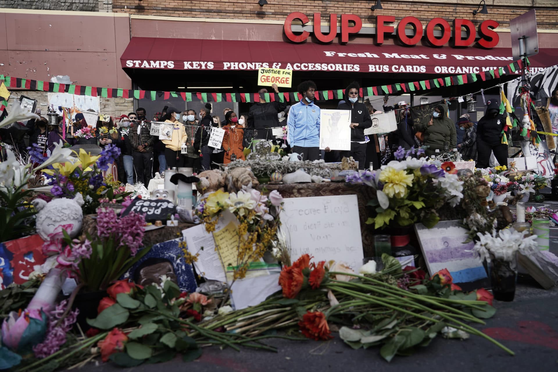 People gather at Cup Foods in Minneapolis after a guilty verdict was announced at the trial of former officer Derek Chauvin for the 2020 death of George Floyd. (Morry Gash/AP)