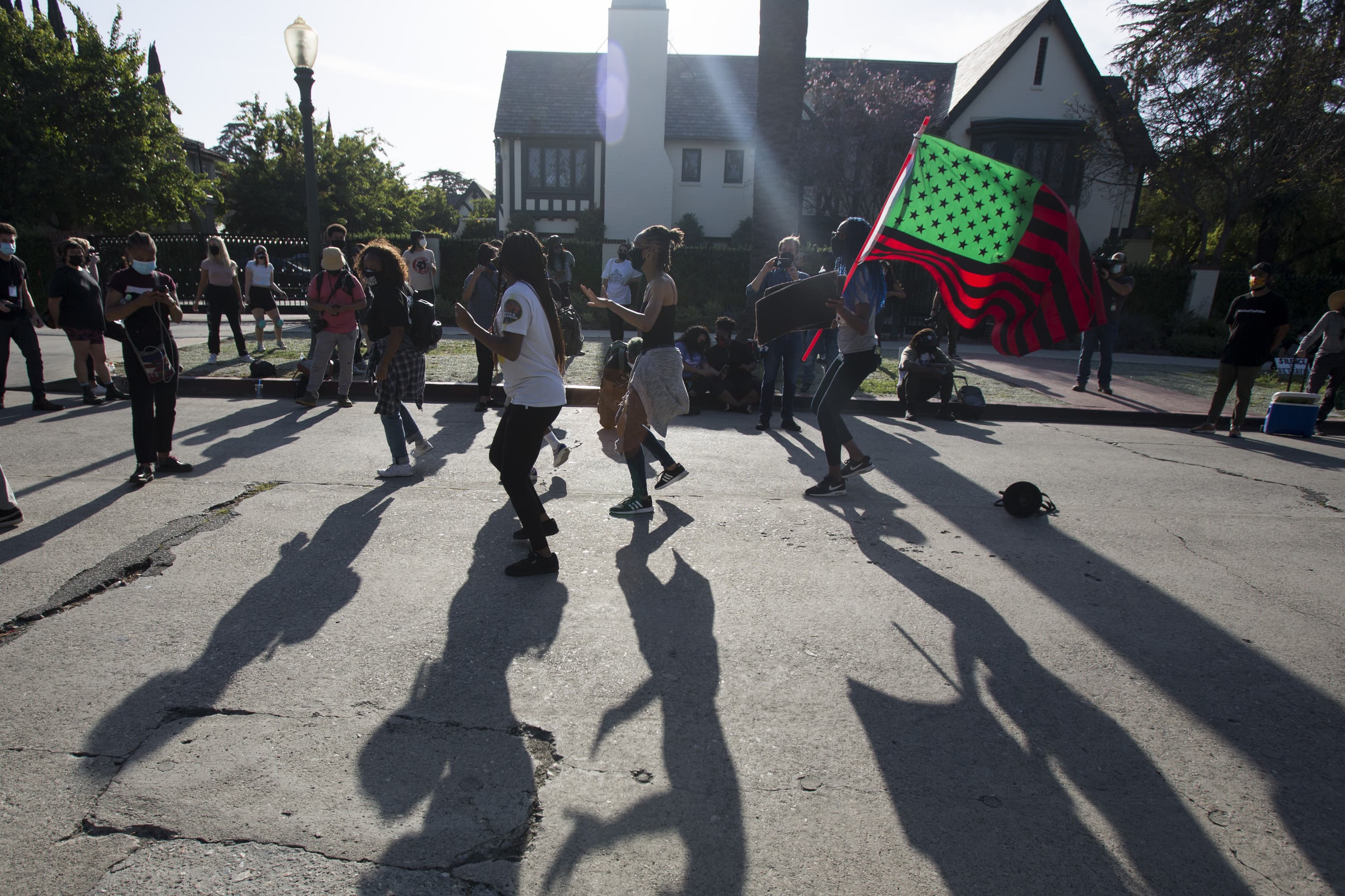 People dance outside Los Angeles Mayor Garcetti's house after a guilty verdict was announced. (Ringo H.W. Chiu/AP)