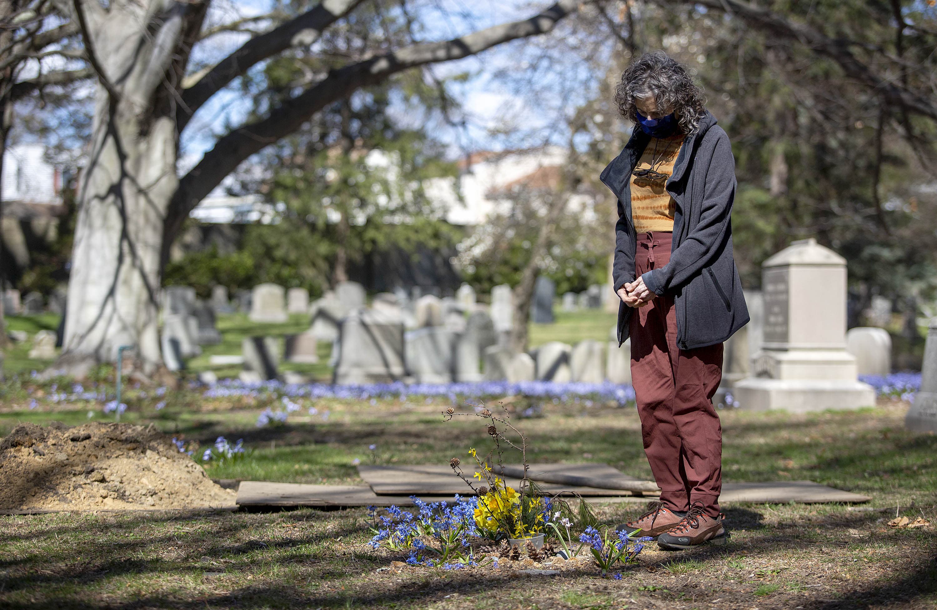 Mishy Lesser stands at the green burial site of her mother, Nettie Lesser. (Robin Lubbock/WBUR)