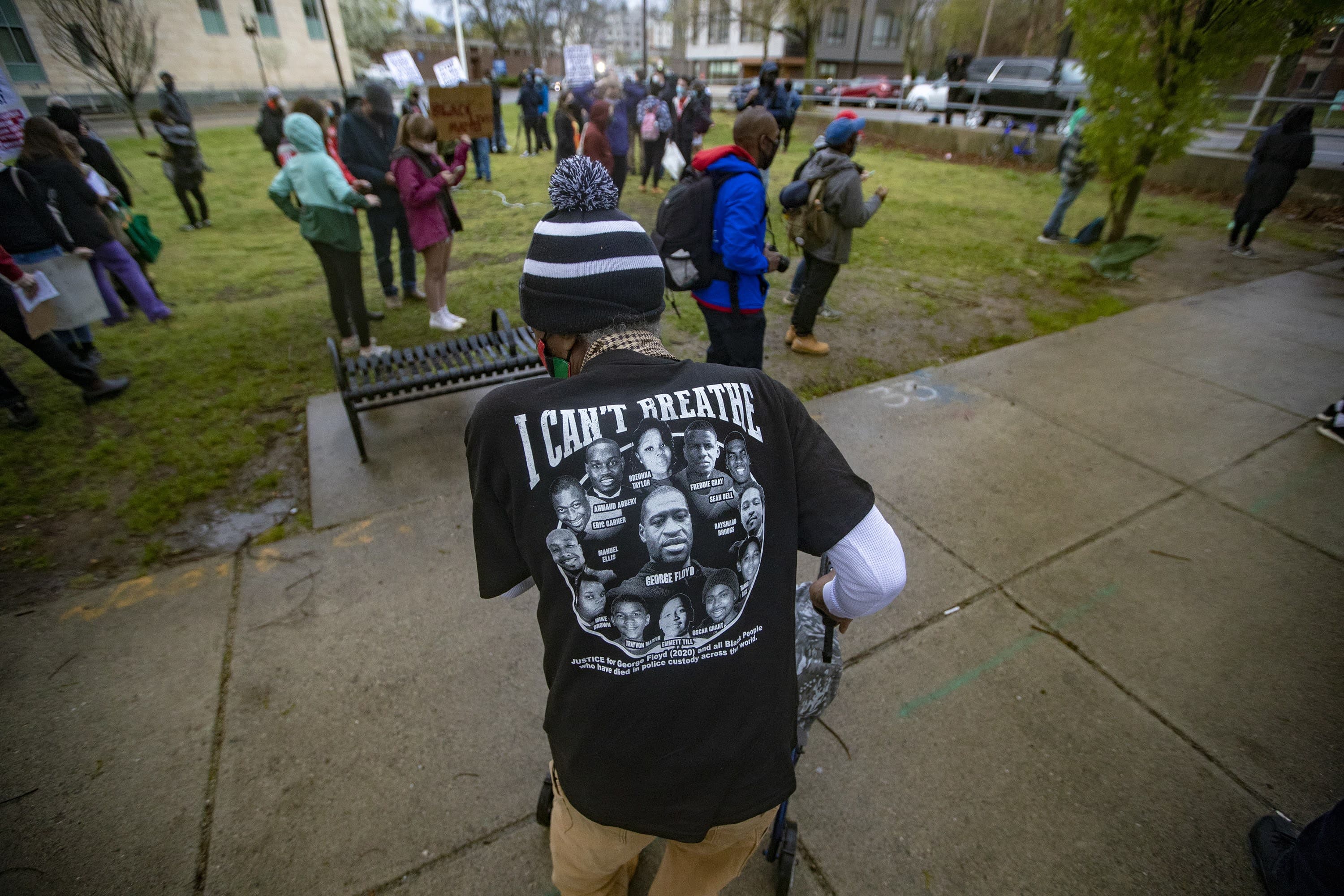 Mr. Marshall Cooper wears a a T-shirt that reads “I CAN’T BREATHE” with the names and faces of those killed by police at a rally. (Jesse Costa/WBUR)