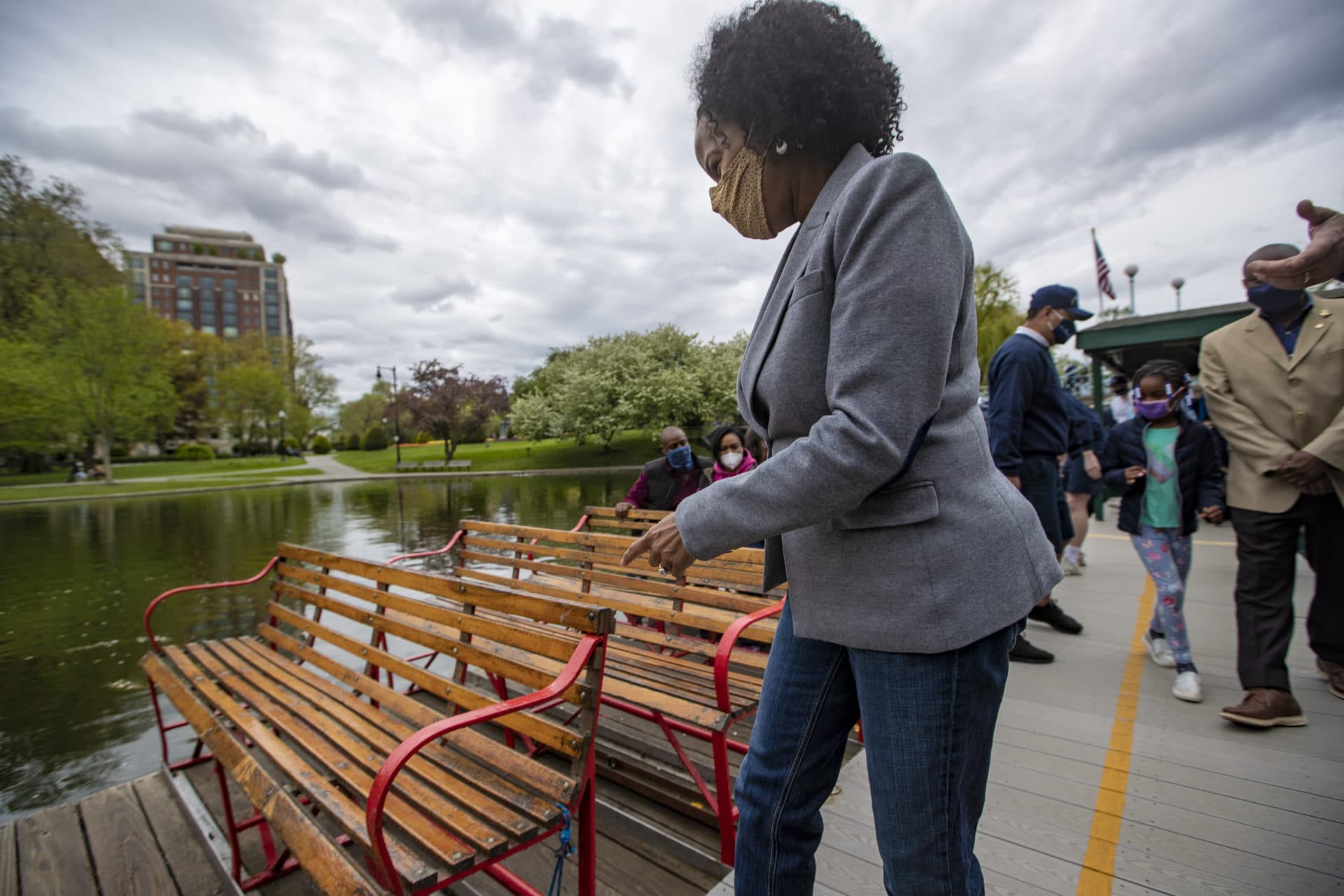 Boston Mayor Kim Janey climbs aboard the first swan boat operating on the Public Garden lagoon. (Jesse Costa/WBUR)