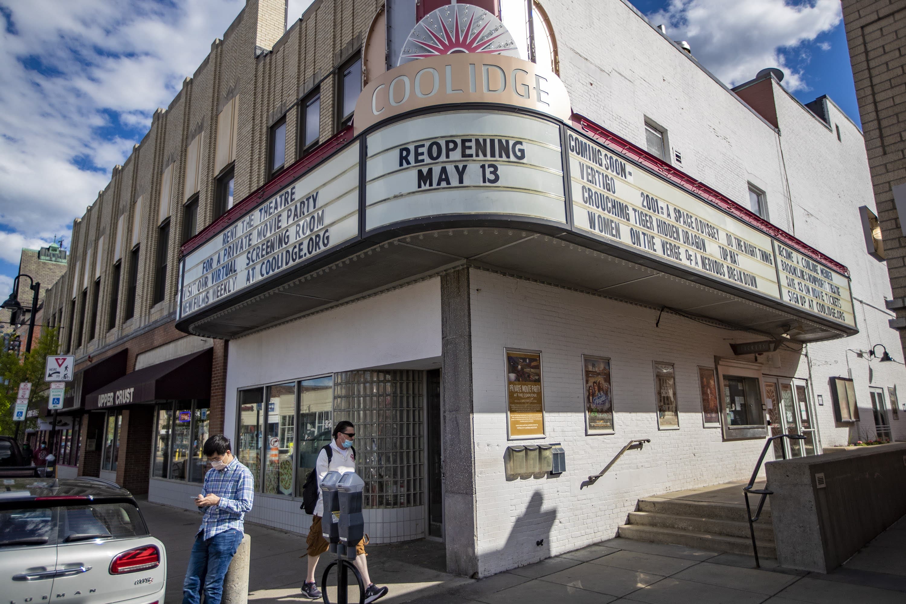 The marquee of the Coolidge Corner Theater annouces their reopening on May 13 after being closed to the public for 14 months due to the pandemic. (Jesse Costa/WBUR)