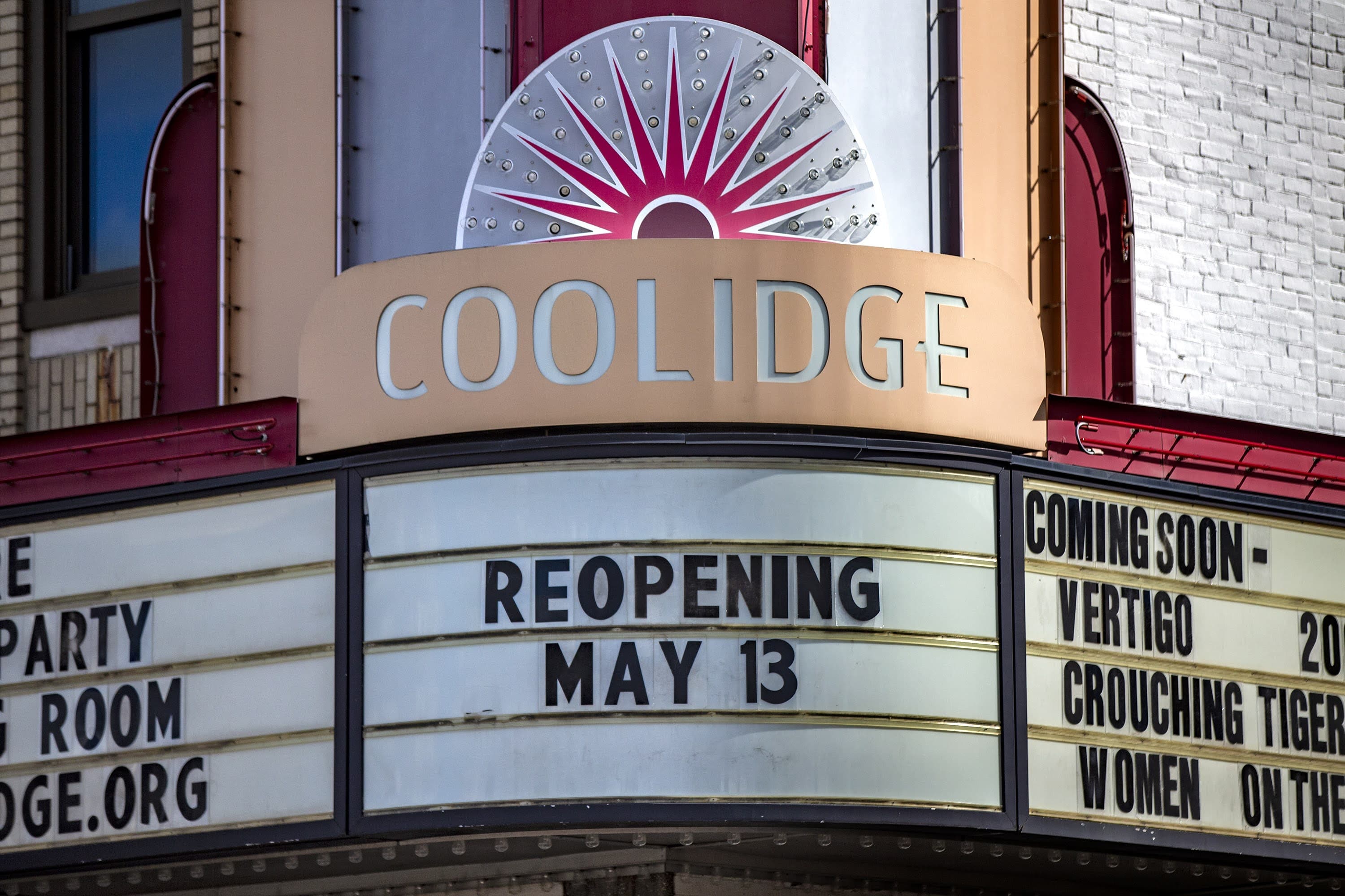 The marquee of the Coolidge Corner Theater announces their reopening on May 13 after being closed to the public for 14 months due to the pandemic. (JesseCosta/WBUR)
