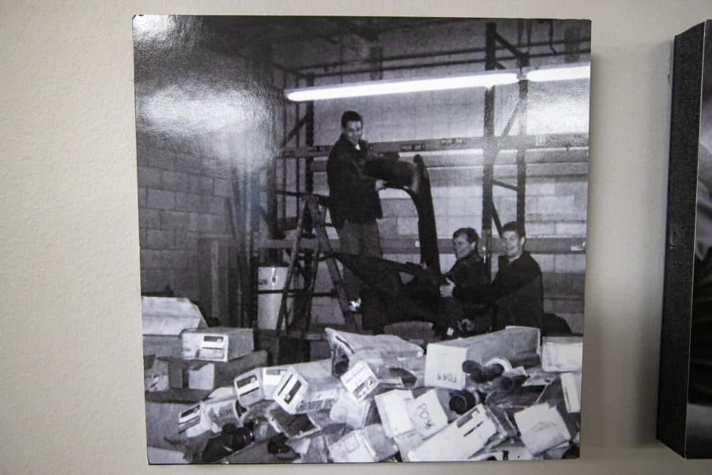A photo of the very first days of 1A Auto Parts, 22 years ago, hangs on an office wall. (Jesse Costa/WBUR)