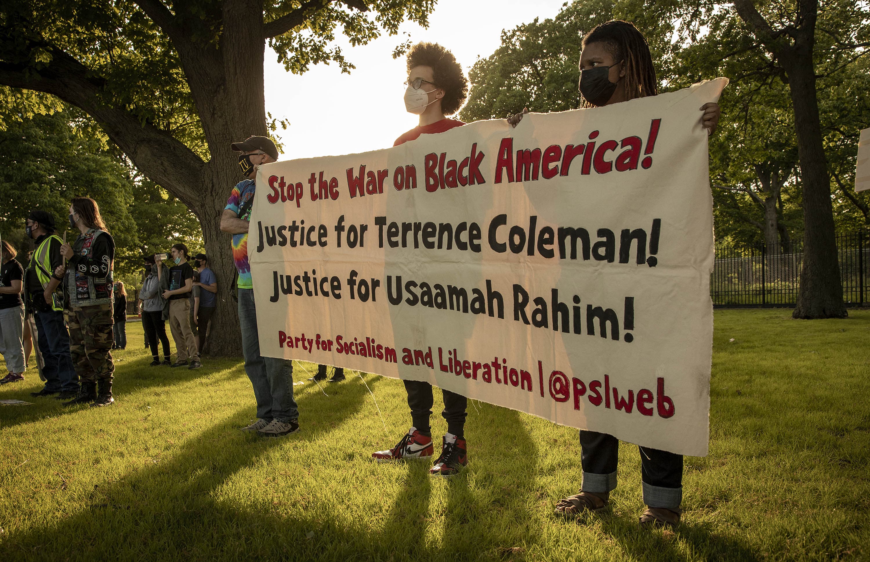 Protesters listen to speakers at the Mass. Action Against Police Brutality rally in Franklin Park on the anniversary of the death of George Floyd. (Robin Lubbock/WBUR)
