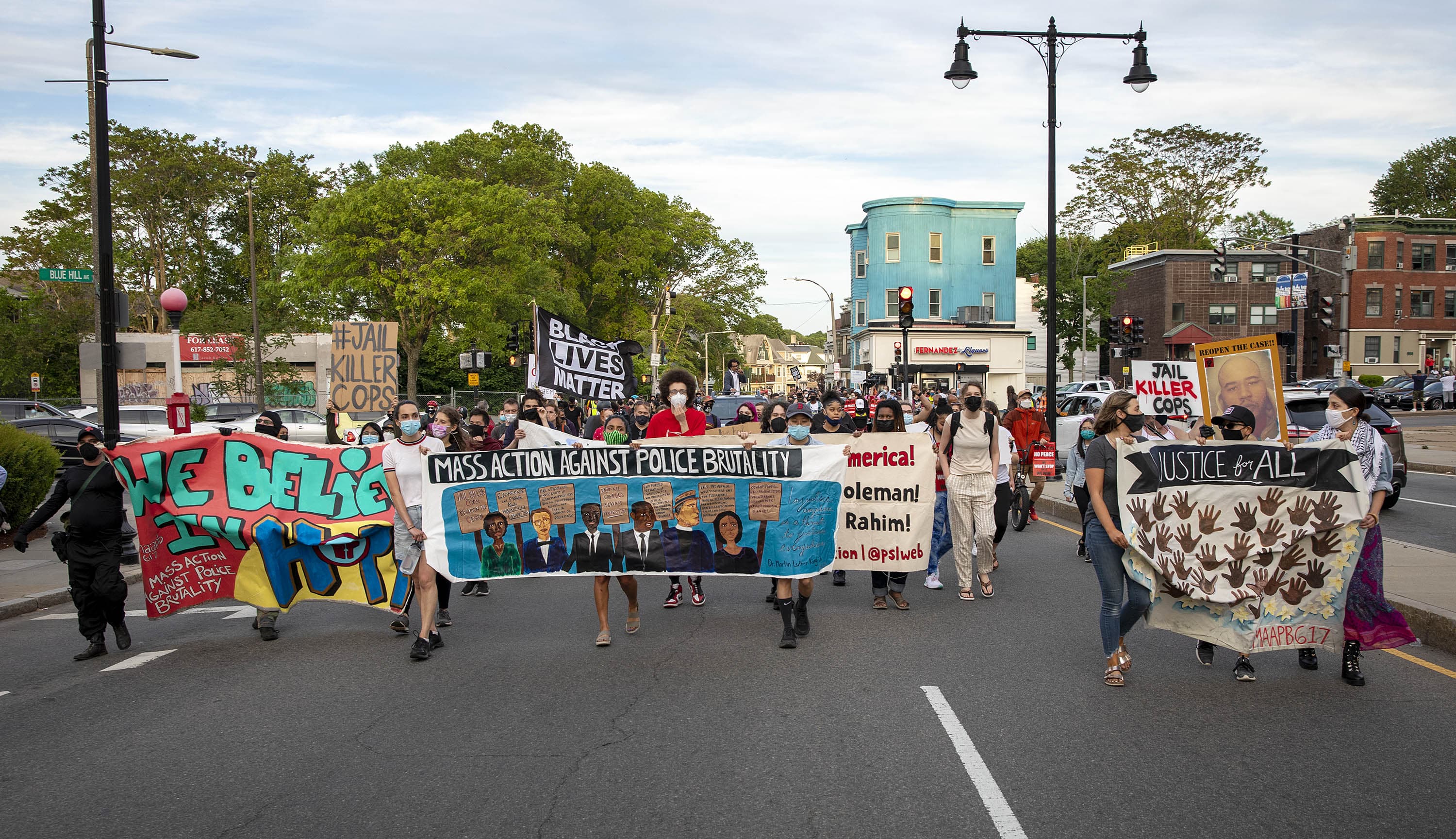 Demonstrators from the Mass. Action Against Police Brutality rally march along Seaver Street in Boston on Tuesday night. (Robin Lubbock/WBUR)