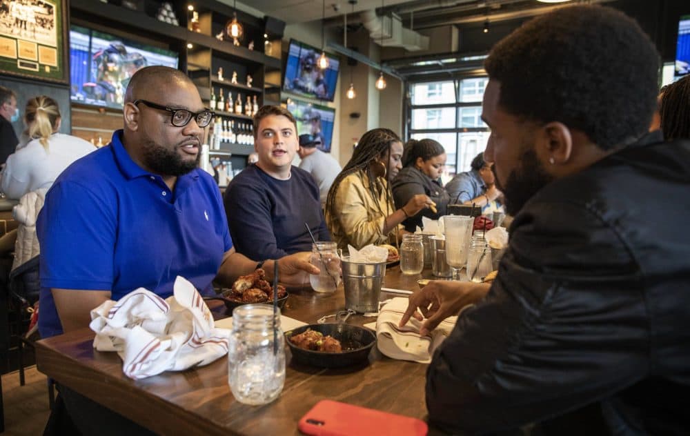 Leonard Rowan has lunch with friends at the A&amp;B Kitchen • Bar, on Saturday, the first day all restrictions on indoor gatherings are lifted in Boston. (Robin Lubbock/WBUR)