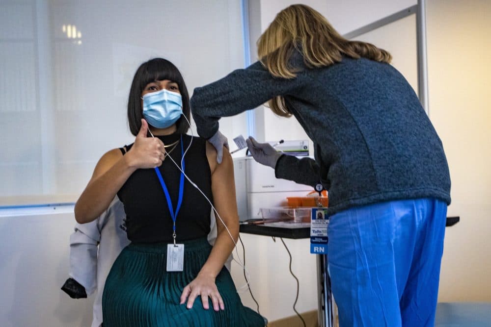 Dr. Gabriela Andujar Vazquez receives the first coronavirus vaccine administered at Tufts Medical Center on Dec. 15, 2020. (Jesse Costa/WBUR)