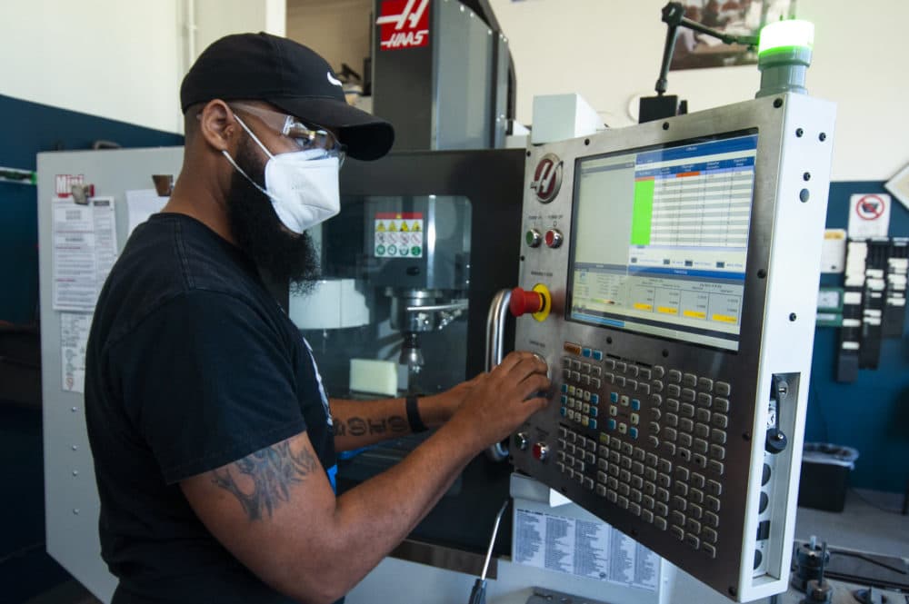 Adonis Summerville punching in instructions to a computer numerical control (CNC) machine at the Jane Addams Resource Corporation (JARC). (Chris Bentley/Here &amp; Now)