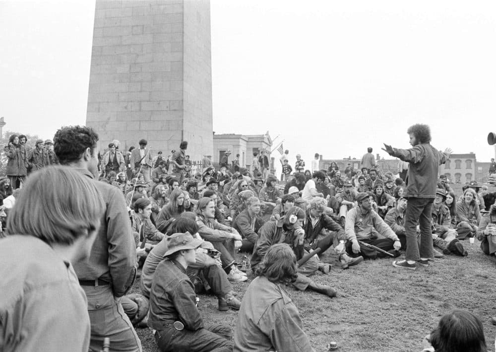 A leader of the Vietnam Veterans Against the War calls for silence as they meet at the base of the Bunker Hill in Boston before setting out for Boston Common on May 31, 1971. (A.E. Maloof/AP)