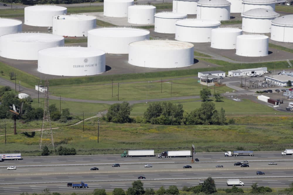 Traffic on I-95 passes oil storage tanks owned by the Colonial Pipeline Company in Linden, N.J. on Sept. 8, 2008. A major pipeline that transports fuels along the East Coast says it had to stop operations because it was the victim of a cyberattack. (Mark Lennihan/AP)