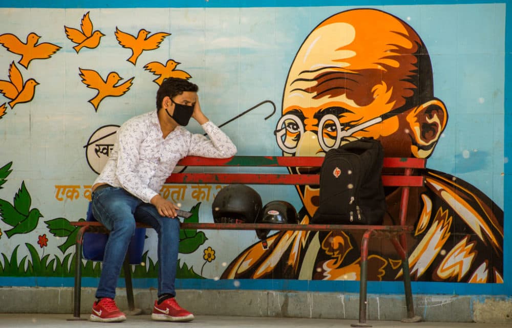 An Indian man wearing a protective mask sits on a bench on April 10, 2020 in New Delhi, India. (Yawar Nazir/Getty Images)