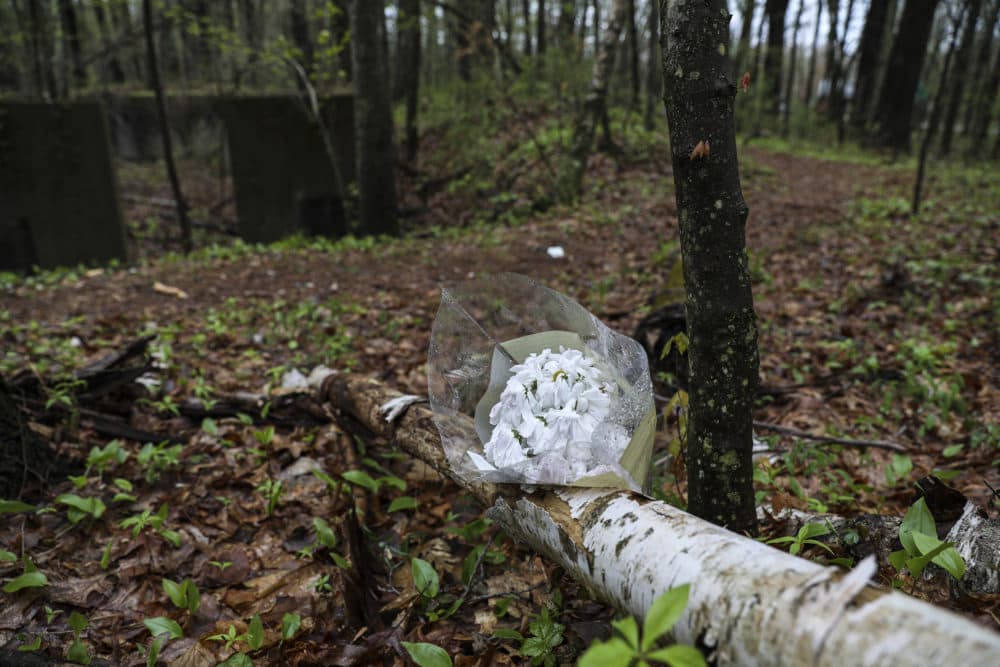 Flowers rest in the woods in Hopkinton on May 4, 2021, nearby where Mikayla Miller was found dead on April 18. (Erin Clark/The Boston Globe via Getty Images)