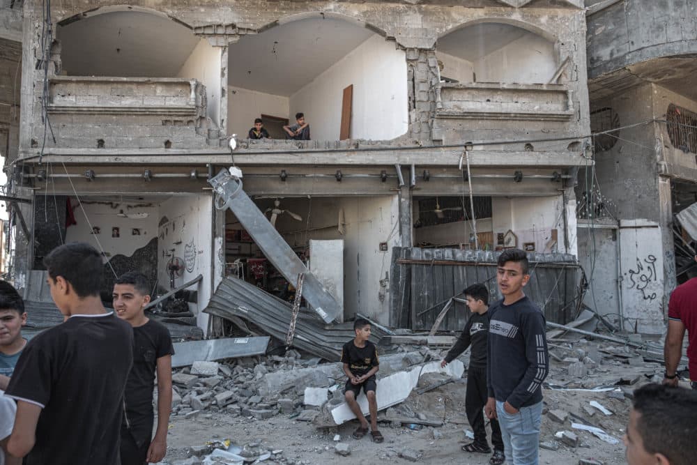 Palestinians inspect damage to buildings in Al-Saftawi street northern Gaza City on May 20, 2021 in Gaza City, Gaza. (Fatima Shbair/Getty Images)