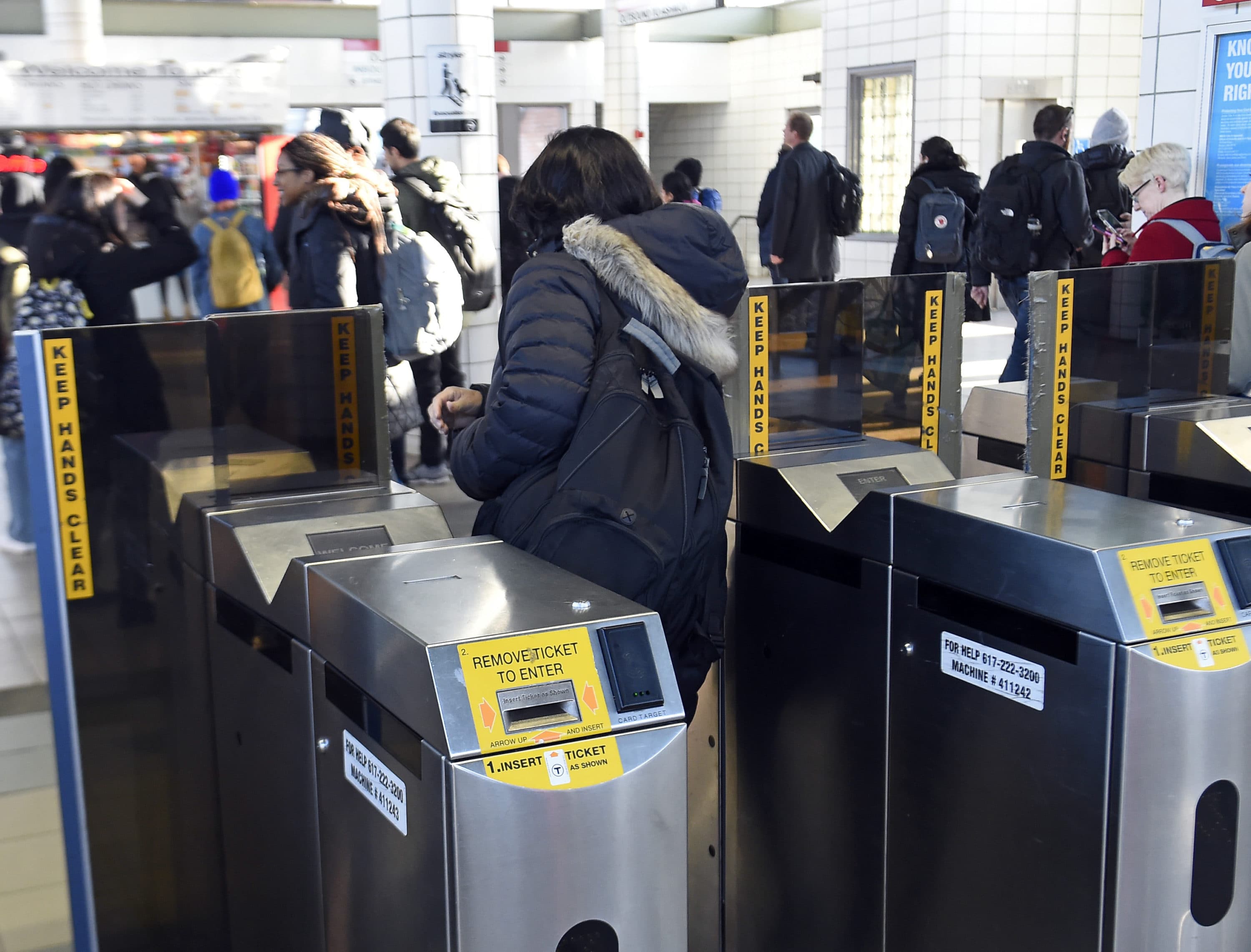 MBTA passengers pass through automated fare collection gates at JFK/UMass Station in Boston on April 4, 2019. (Christopher Evans/MediaNews Group/Boston Herald via Getty Images)