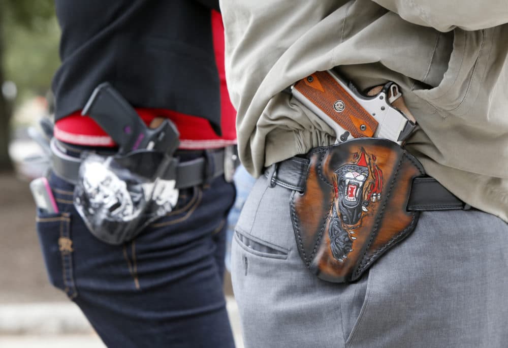 Two people carrying pistols in Texas. (Erich Schlegel/Getty Images)
