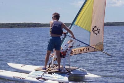 Graham wind surfing on the water. (Courtesy of Stephen Gardner Photography)