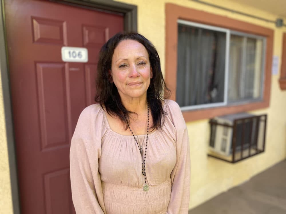 Veronica Marmion outside of her Project Homekey motel room in Los Angeles. She is grateful to be off the streets after being unhoused and could see herself living there for at least a year. (Saul Gonzalez/KQED)