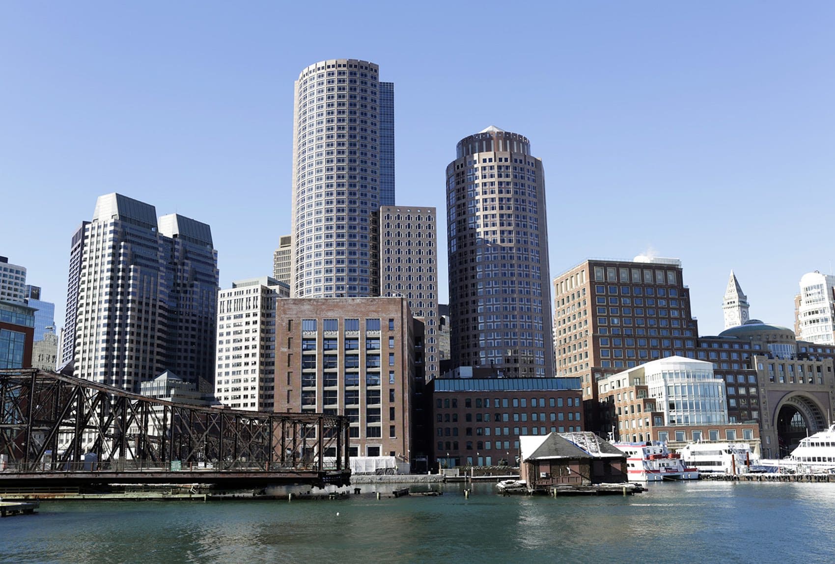 Buildings near Rowes Wharf are seen from the Seaport District in Boston. (Hadley Green for WBUR)
