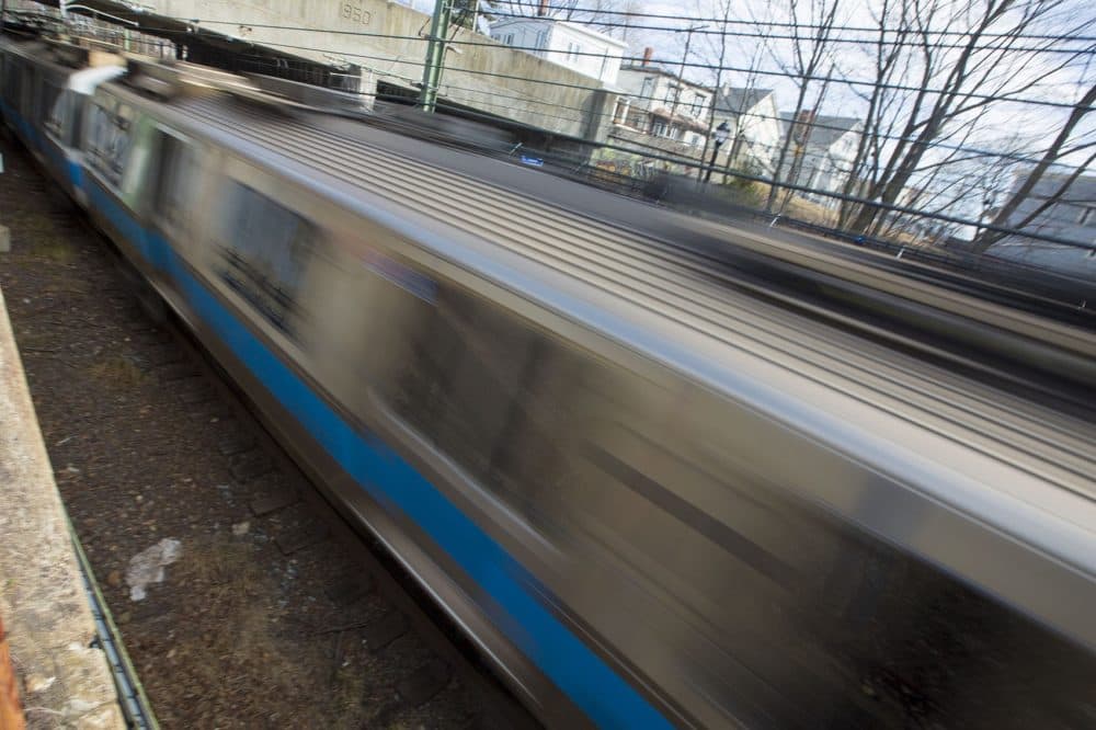 An MBTA Blue Line train rushes by, creating a blur. This photo was taken by Jesse Costa of WBUR.