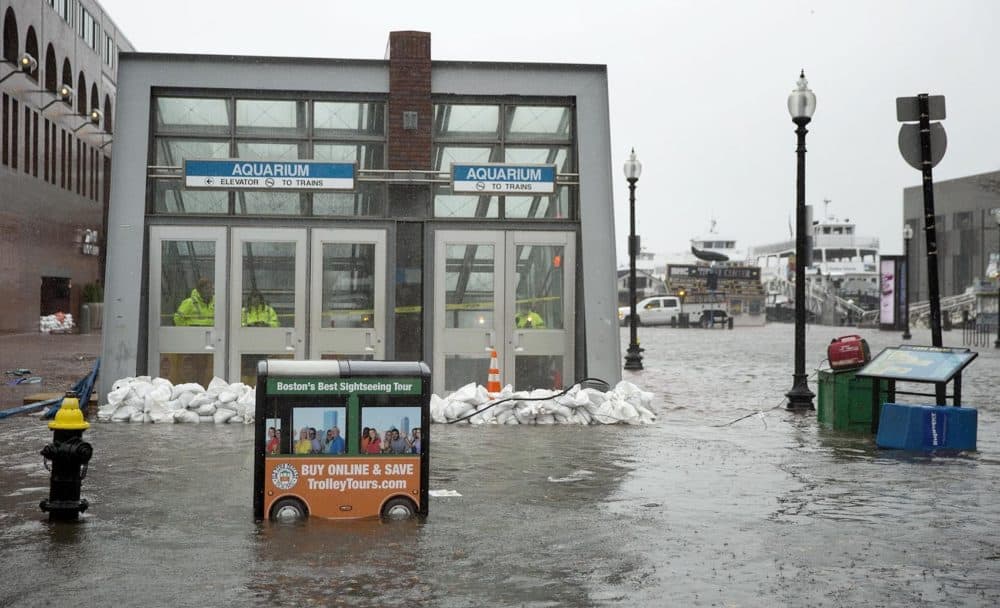 Sandbags hold back the water at the entrance to the Aquarium MBTA station during a nor'easter in 2018. (Robin Lubbock/WBUR)