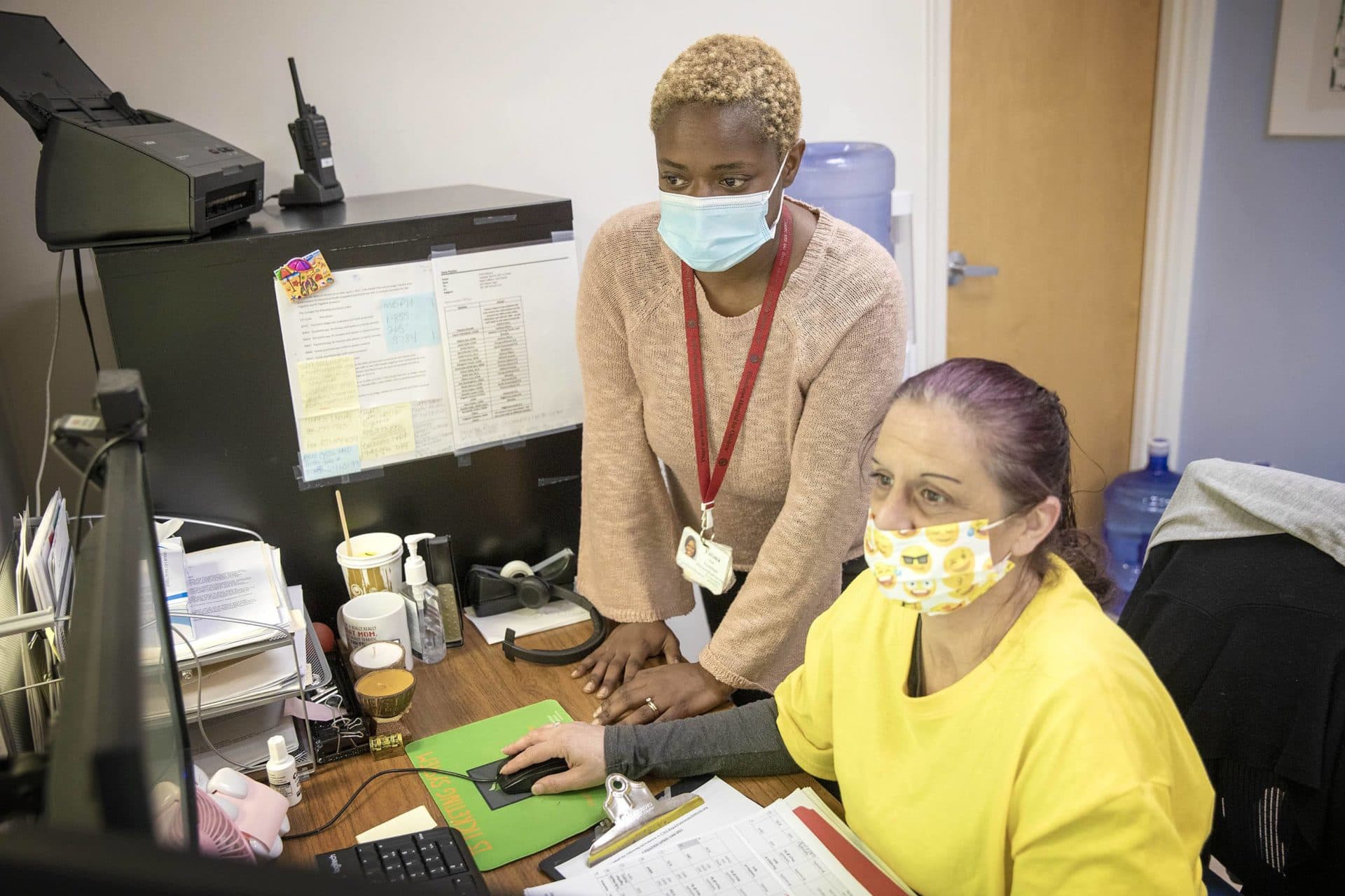 Franciscan Children's Director of Behavioral Health Services Fatima Watt looks over the day's schedule with patient coordinator Karen LeBlanc. (Robin Lubbock/WBUR)