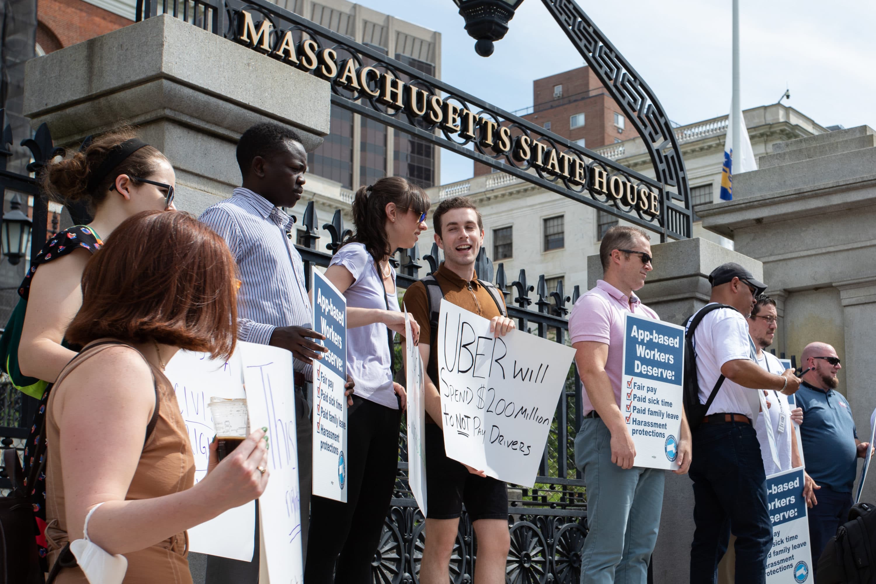 Supporters of the Coalition to Protect Workers' Rights stand outside the State House during a campaign kickoff event Tuesday morning. (Chris Van Buskirk/SHNS)