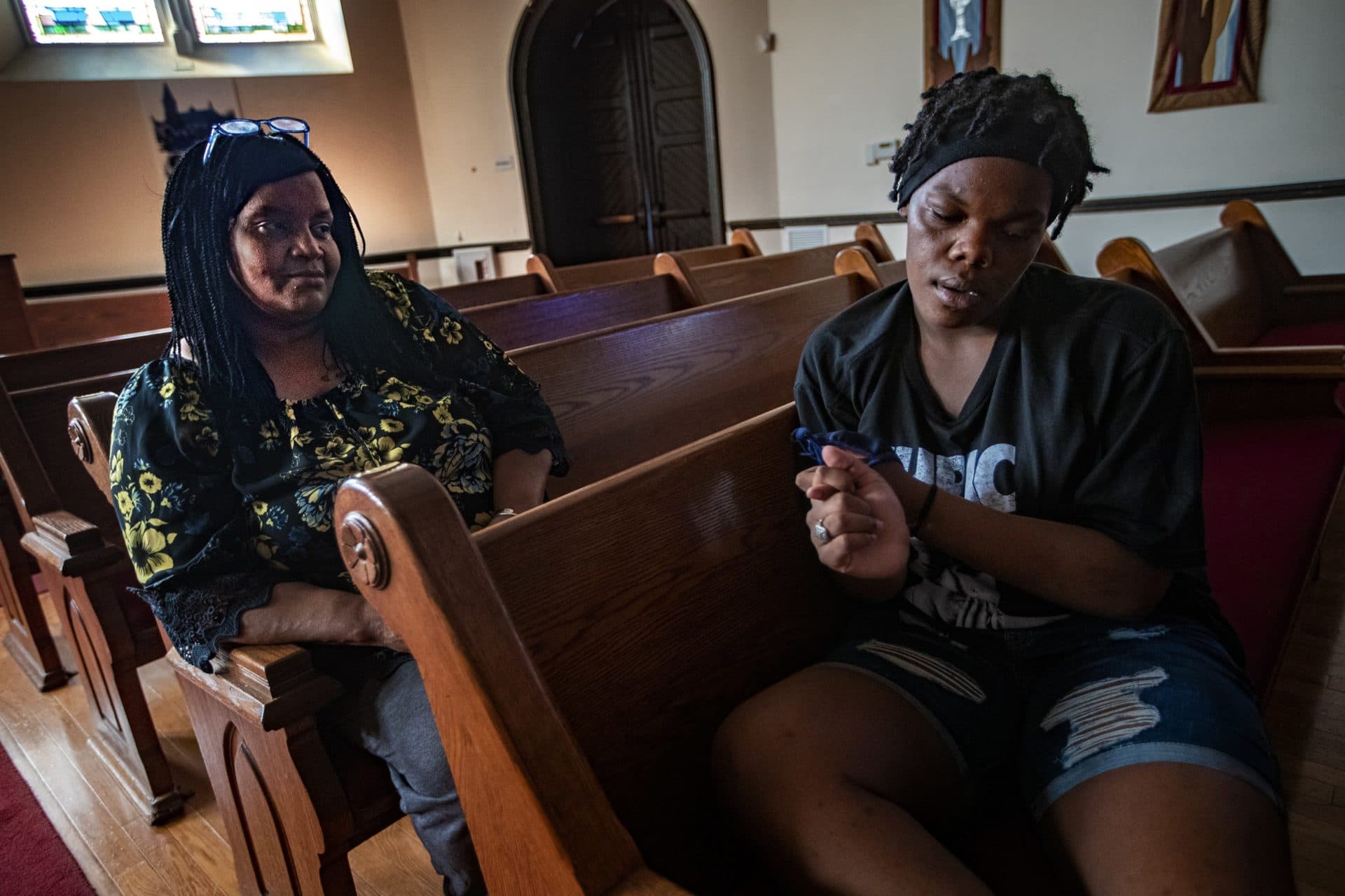 Mahailya Effee, right, speaks with Shondell Davis, the community trauma healing specialist with the Cory Johnson Program for Post-Traumatic Healing, at Roxbury Presbyterian Church. (Jesse Costa/WBUR)