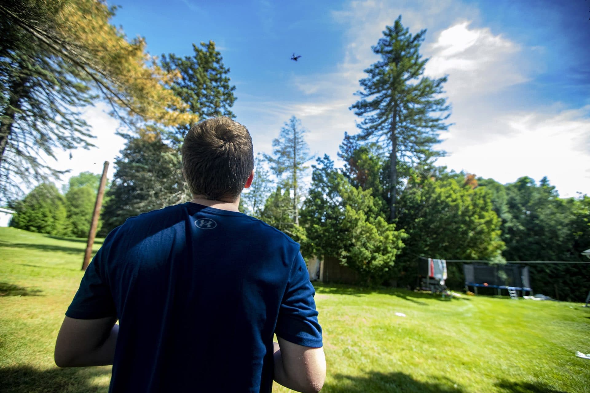 Charlie, 12, flies a drone in the backyard of his home in West Springfield. (Jesse Costa/WBUR)