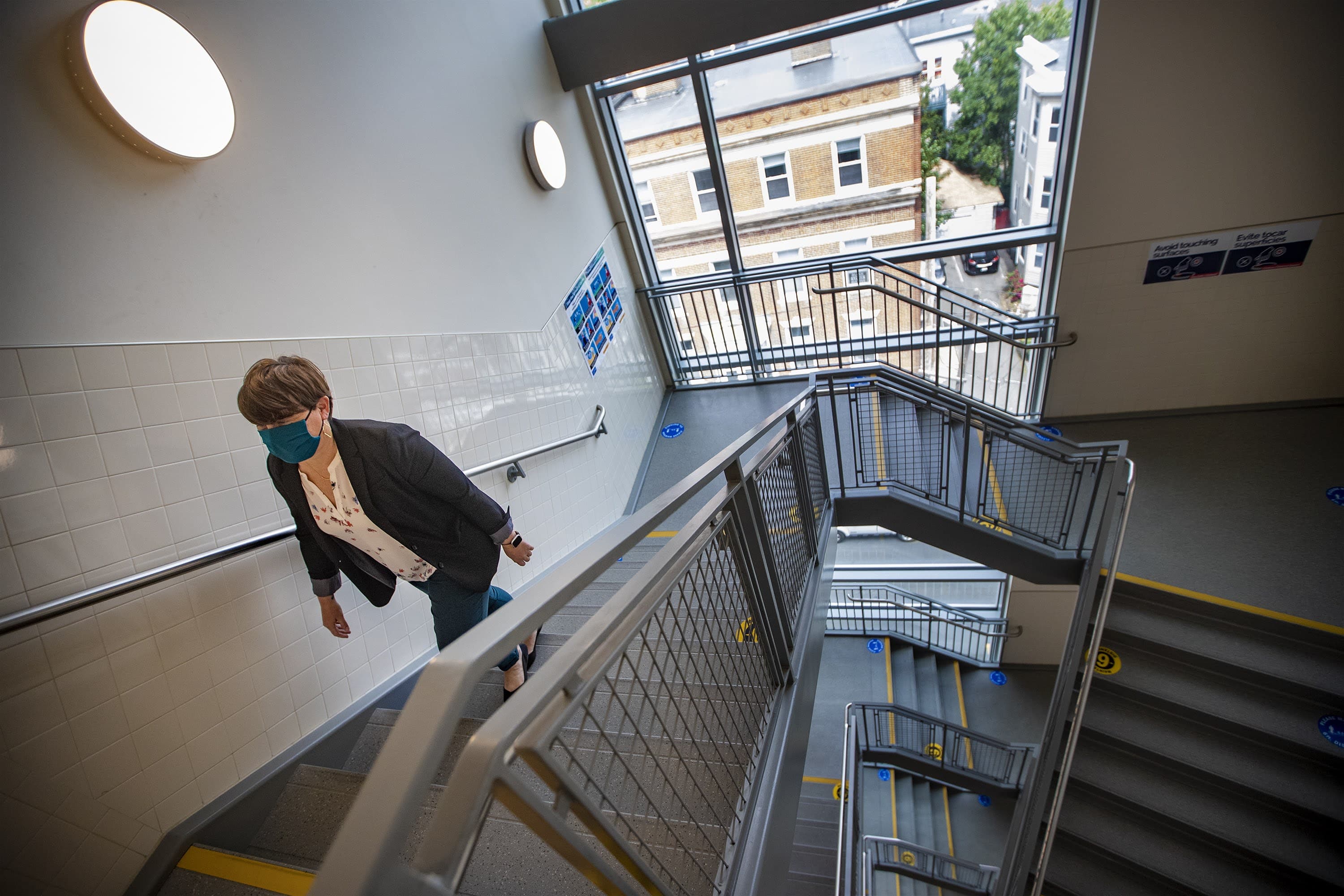 Coordinator of Social Work Services at Chelsea Public Schools Kim Huffer walks up a stairway of the Clark Avenue Middle School. (Jesse Costa/WBUR)