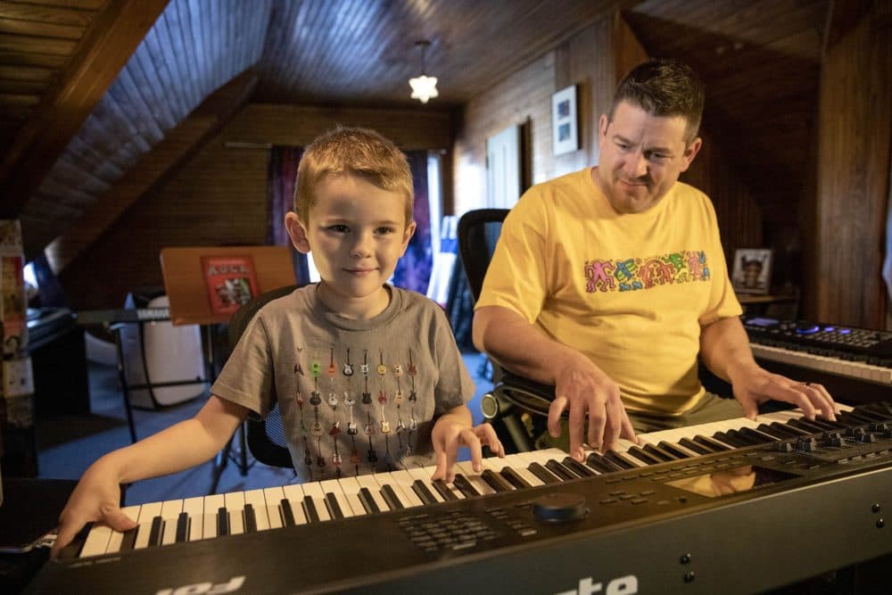 Musician and author David Weiser and his son Arlen play a keyboard together in David's studio. (Robin Lubbock/WBUR)
