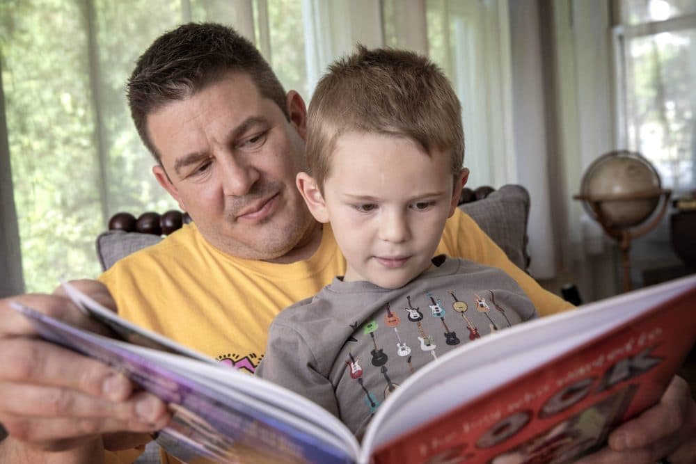 David Weiser reads &quot;The Boy Who Wanted to Rock&quot; with his son Arlen, who is featured in the book. (Robin Lubbock/WBUR)