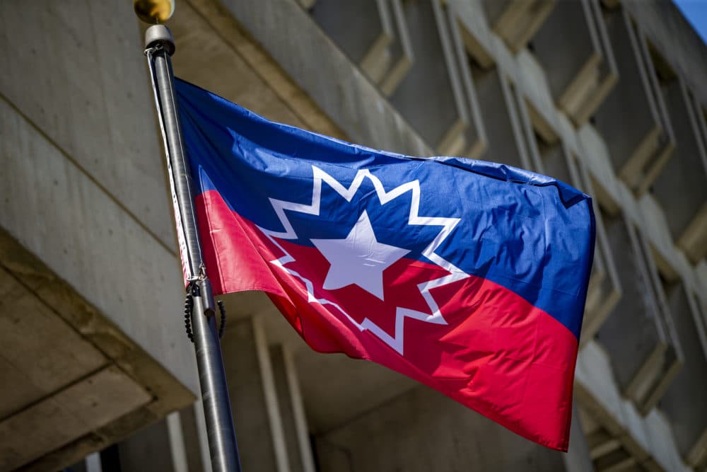 The Juneteenth flag flies in front of Boston City Hall on Congress Street. (Jesse Costa/WBUR)