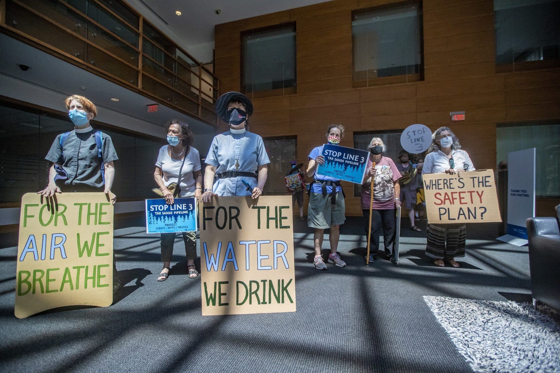 Protesters enter the lobby of the Enbridge office in Waltham. (Jesse COsta/WBUR)