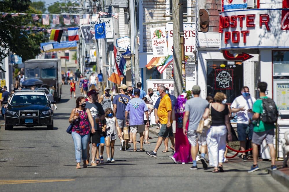 Tourists walk along Commercial Street in Provincetown in July 2020. (Jesse Costa/WBUR)