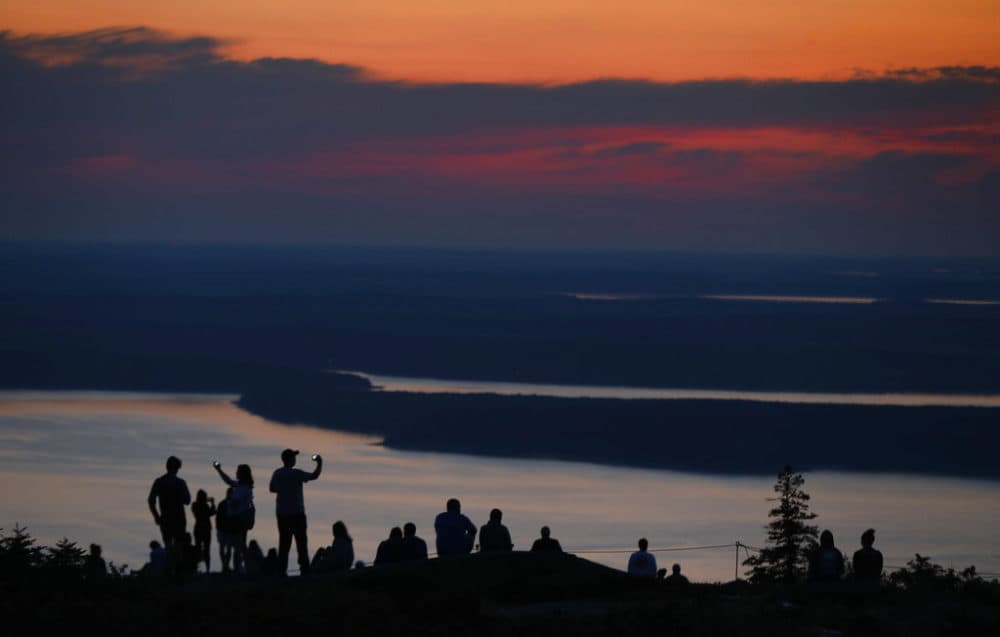 A crowd gathers near the summit of Cadillac Mountain in Acadia National Park. (Robert F. Bukaty/AP Photo)