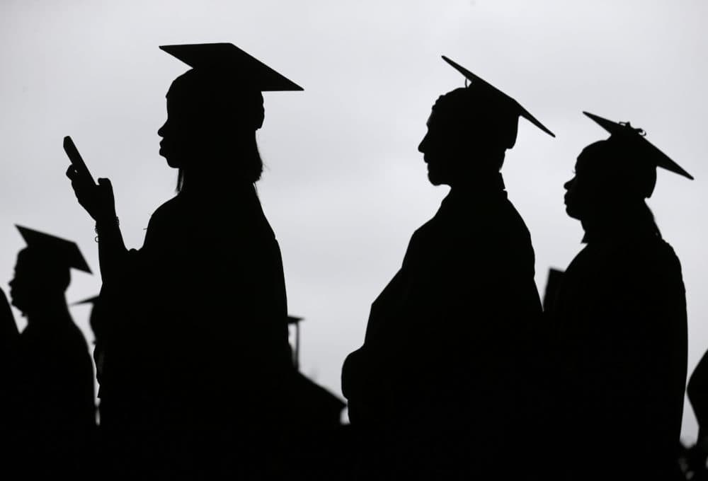 Graduates line up before the start of commencement. (Seth Wenig/AP)