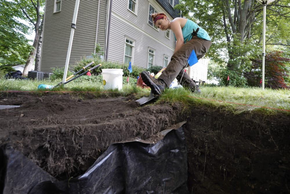 UMass Boston graduate student Claire Norton uses a shovel to remove layers of soil while working to uncover artifacts at an excavation site on Wednesday. (Steven Senne/AP)
