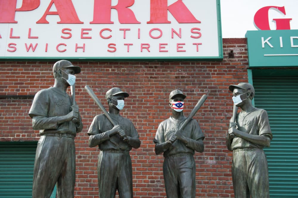 A mask is placed on the Teammates Statue on Ispwich Street on Opening Day at Fenway Park on July 24, 2020 in Boston, Massachusetts. (Kathryn Riley/Getty Images)