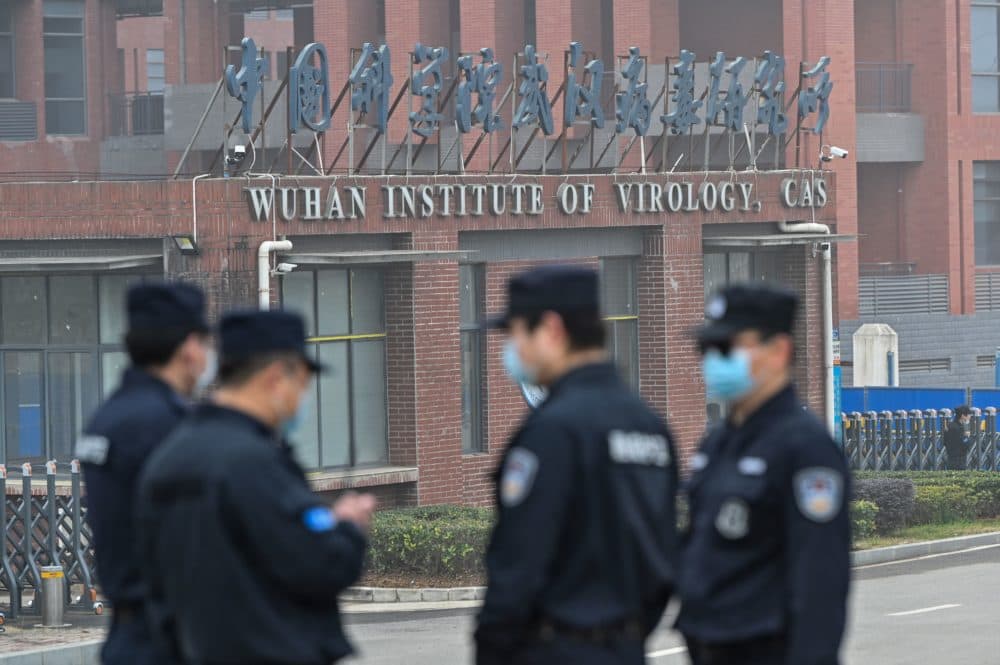 Security personnel stand guard outside the Wuhan Institute of Virology in Wuhan as members of the World Health Organization (WHO) team investigating the origins of the COVID-19 coronavirus make a visit to the institute in Wuhan in China's central Hubei province on Feb. 3, 2021. (Photo by Hector Retamal/AFP via Getty Images)
