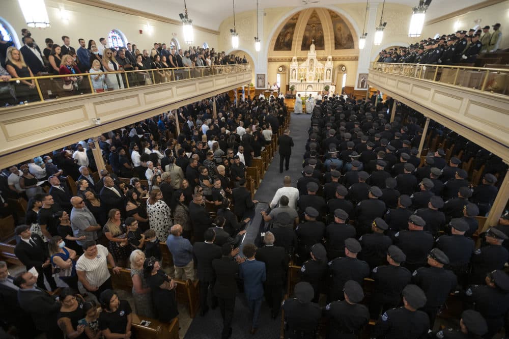 WORCESTER - The casket of fallen Worcester Police Officer Enmanuel Familia is escorted into his funeral Mass at St. John Church in Worcester, Massachusetts Thursday, June 10, 2021. ASHLEY GREEN / TELEGRAM & GAZETTE