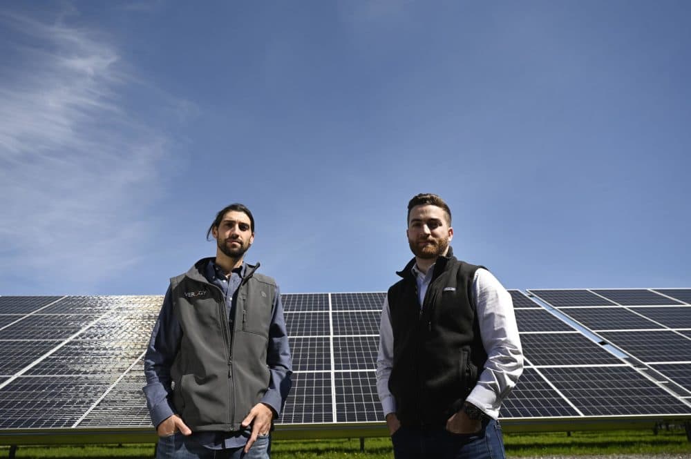 Verogy CEO Will Herschel and Bryan Fitzgerald, director of development, stand next to a field of solar panels they developed on unused cemetery land in Torrington. (Joe Amon/Connecticut Public)