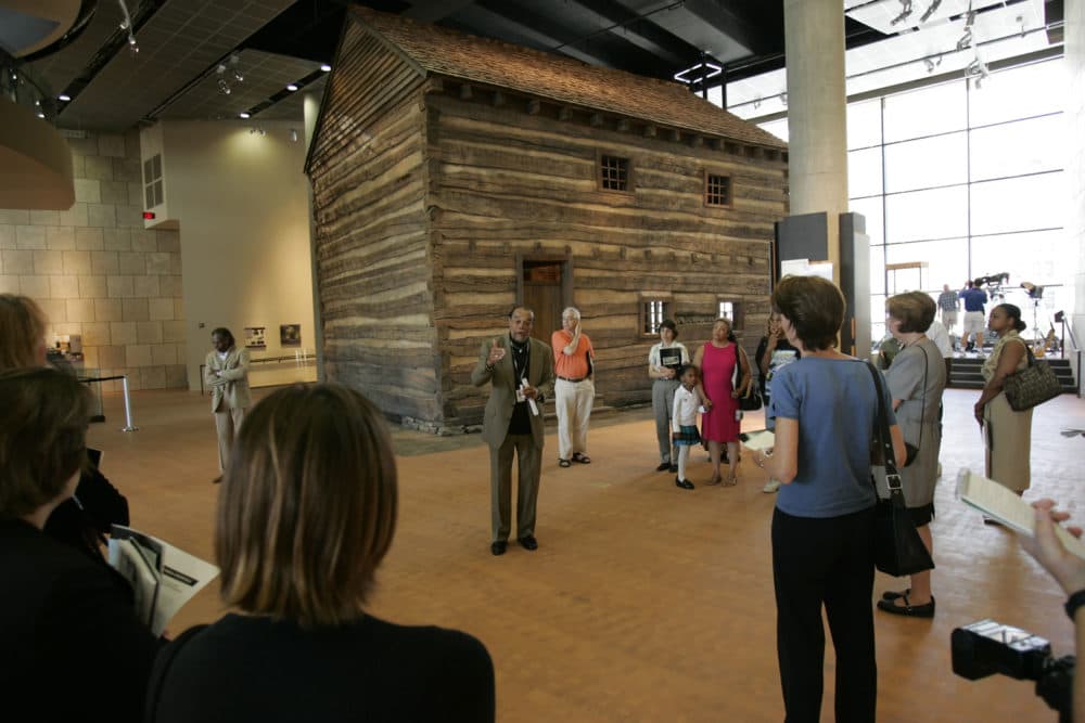 The largest artifact at the National Underground Railroad Freedom Center is an authentic slave pen. Visitors listen to Carl B. Westmoreland, the senior historian and curator of the slave pen, tell the story of this significant artifact. (National Underground Railroad Freedom Center in Cincinnati)