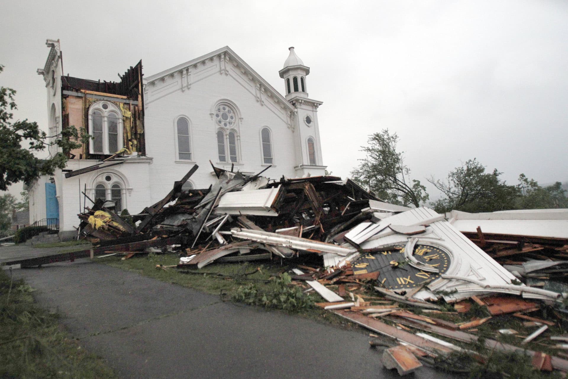 In this June 1, 2011 file photo, the steeple of The First Church of Monson, Mass., lies in rubble on the ground after a tornado blew through. (Elise Amendola/AP)