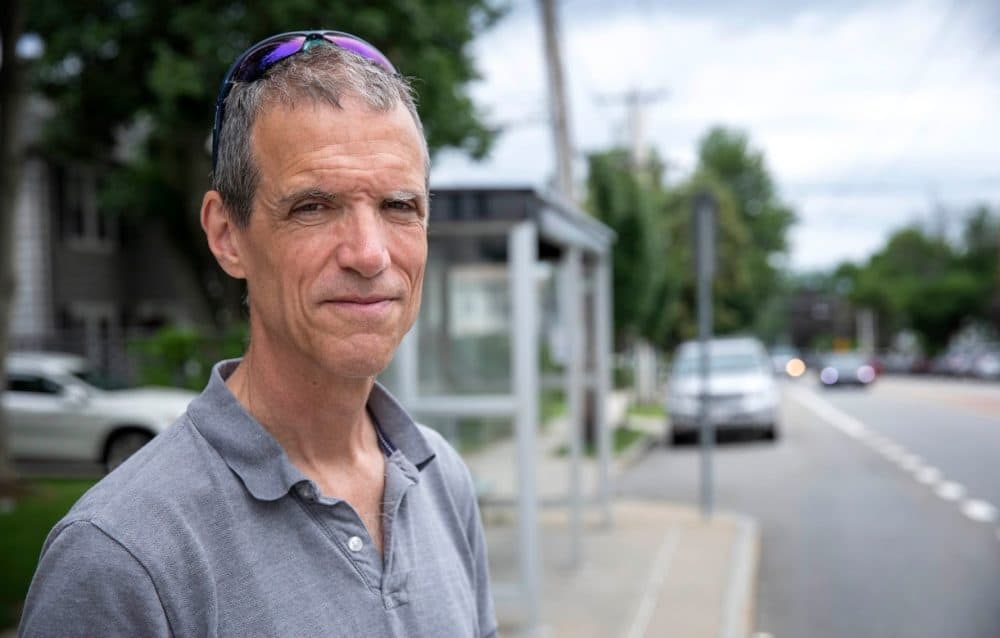 Senator Will Brownsberger standing at a bus stop in Belmont. (Robin Lubbock/WBUR)