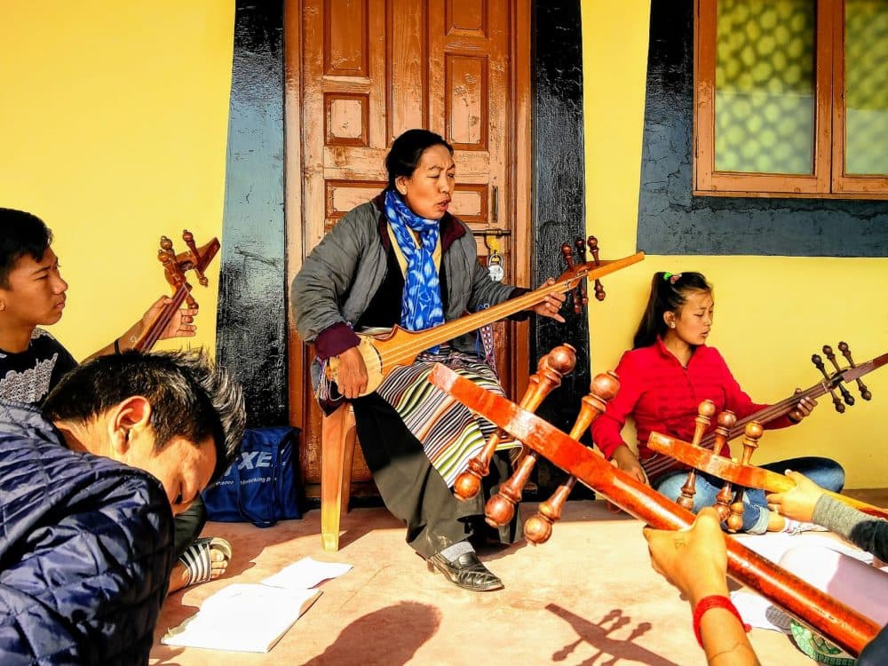 A Tibetan woman teaches dranyen at the Tibetan Institute of Performing Arts in Dharamshala, India.