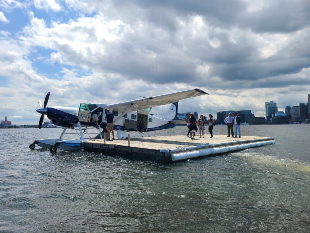 After a short ferry ride, people board a Tailwind seaplane in Boston Harbor. (Tibisay Zea/WBUR)