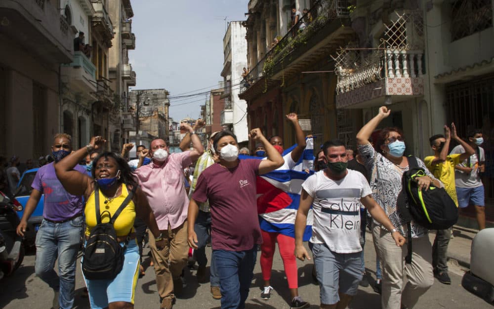 Government supporters shout slogans as anti-government protesters march in Havana, Cuba. Hundreds of demonstrators went out to the streets in several cities in Cuba to protest against ongoing food shortages and high prices of foodstuffs. (Ismael Francisco/AP Photo)